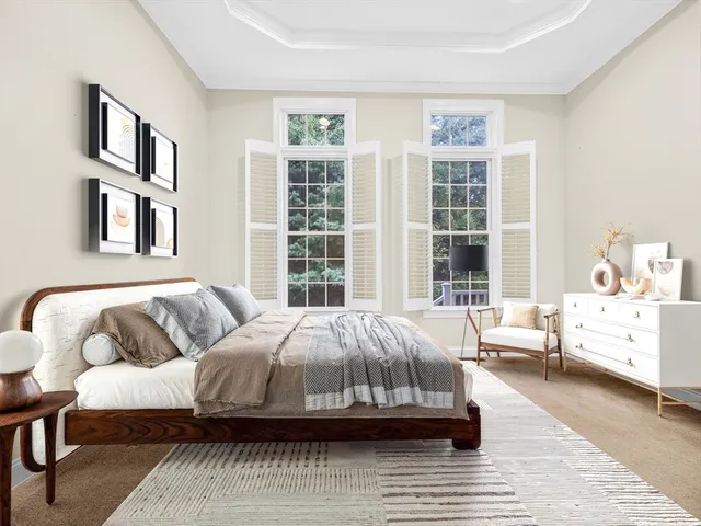 a bedroom with a bed and a large window
