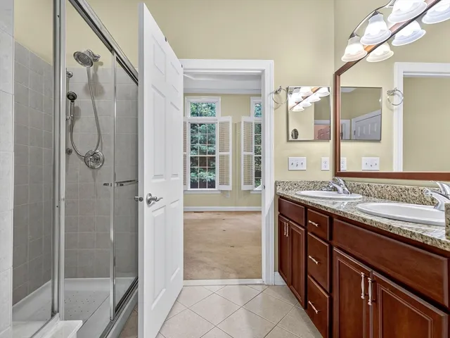 a bathroom with a granite countertop sink mirror and double