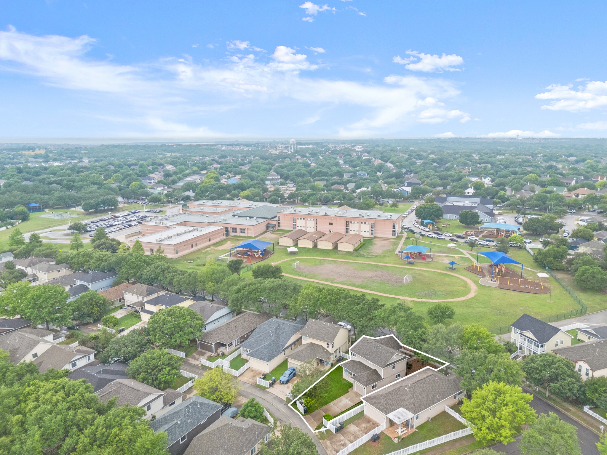 360 Sampson Kyle, TX 78640 - Photo 36 of 36 Aerial perspective showcasing a residential property with a multi-level structure and a fenced yard