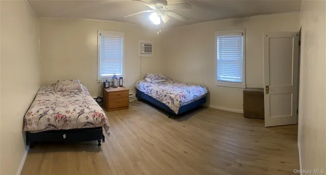 a bedroom with two beds and a chandelier