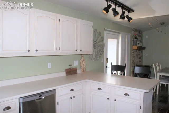 a kitchen with stainless steel appliances a refrigerator sink and cabinets