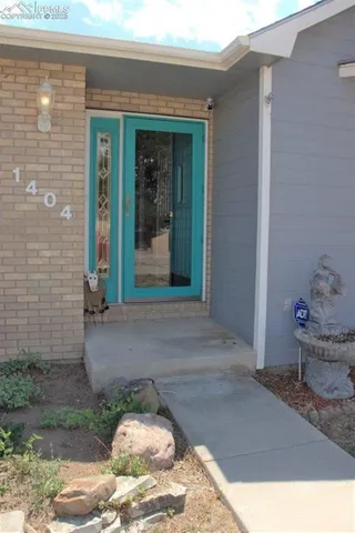 a white house with a yard and parking space