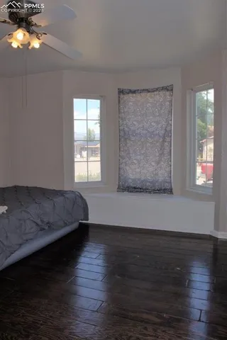 a bed sitting in a bedroom next to a window