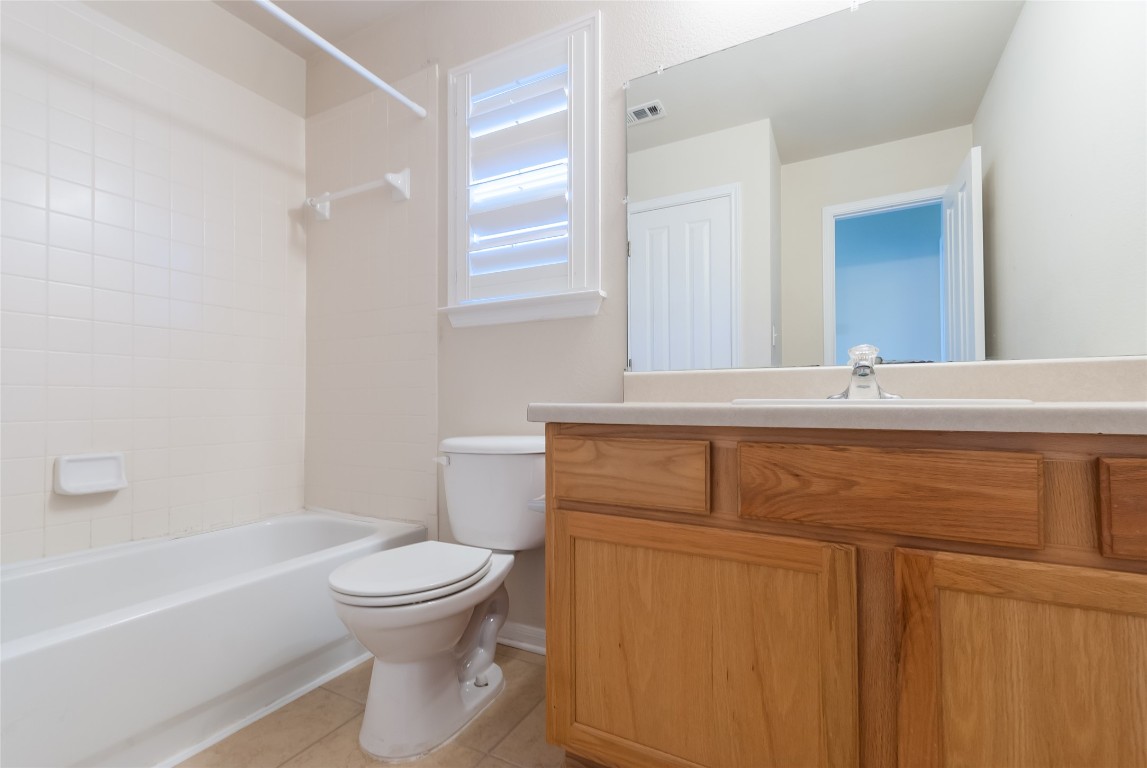 1101 Hidden View Place Round Rock, TX 78665 - Photo 18 of 37 a bathroom with a toilet sink and mirror