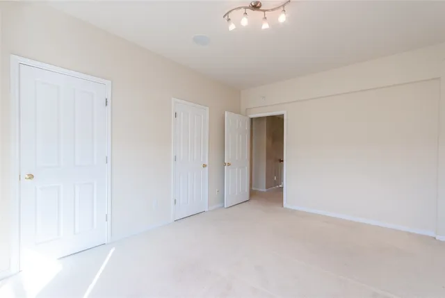 a living room with a bed furniture and a ceiling fan