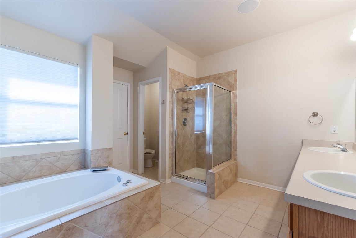 1101 Hidden View Place Round Rock, TX 78665 - Photo 26 of 37 a bathroom with a tub shower and sink