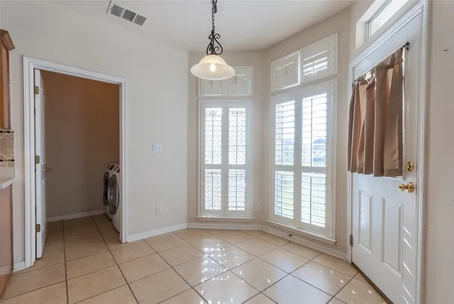 a view of an entryway with wooden floor and a window