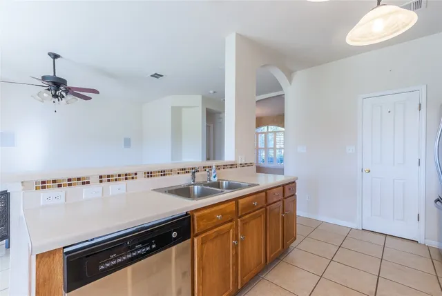 a kitchen with a sink appliances and cabinets