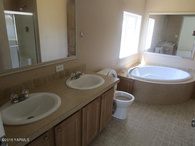 11303 Gilbert Road Yakima, WA 98903 - Photo 25 of 28 a bathroom with a toilet sink and mirror