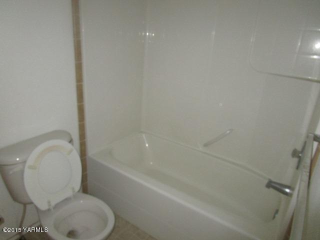 11303 Gilbert Road Yakima, WA 98903 - Photo 27 of 28 a white toilet sitting next to a bath tub