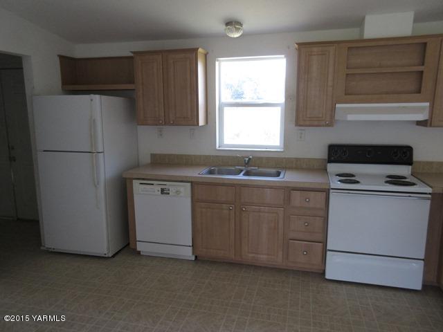 11303 Gilbert Road Yakima, WA 98903 - Photo 6 of 28 a kitchen with cabinets appliances a sink and a window