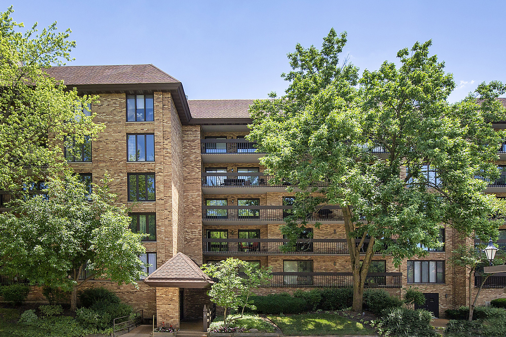 a front view of a building with trees