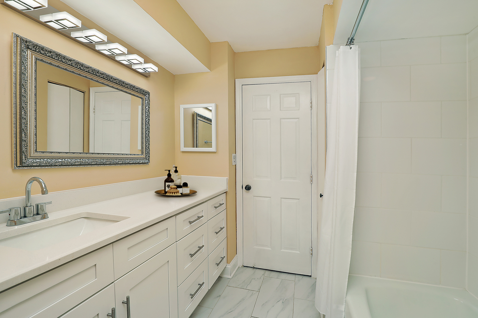 1621 Mission Hills Road, Unit 104 Northbrook, IL 60062 - Photo 13 of 29 a bathroom with a sink a mirror and a shower