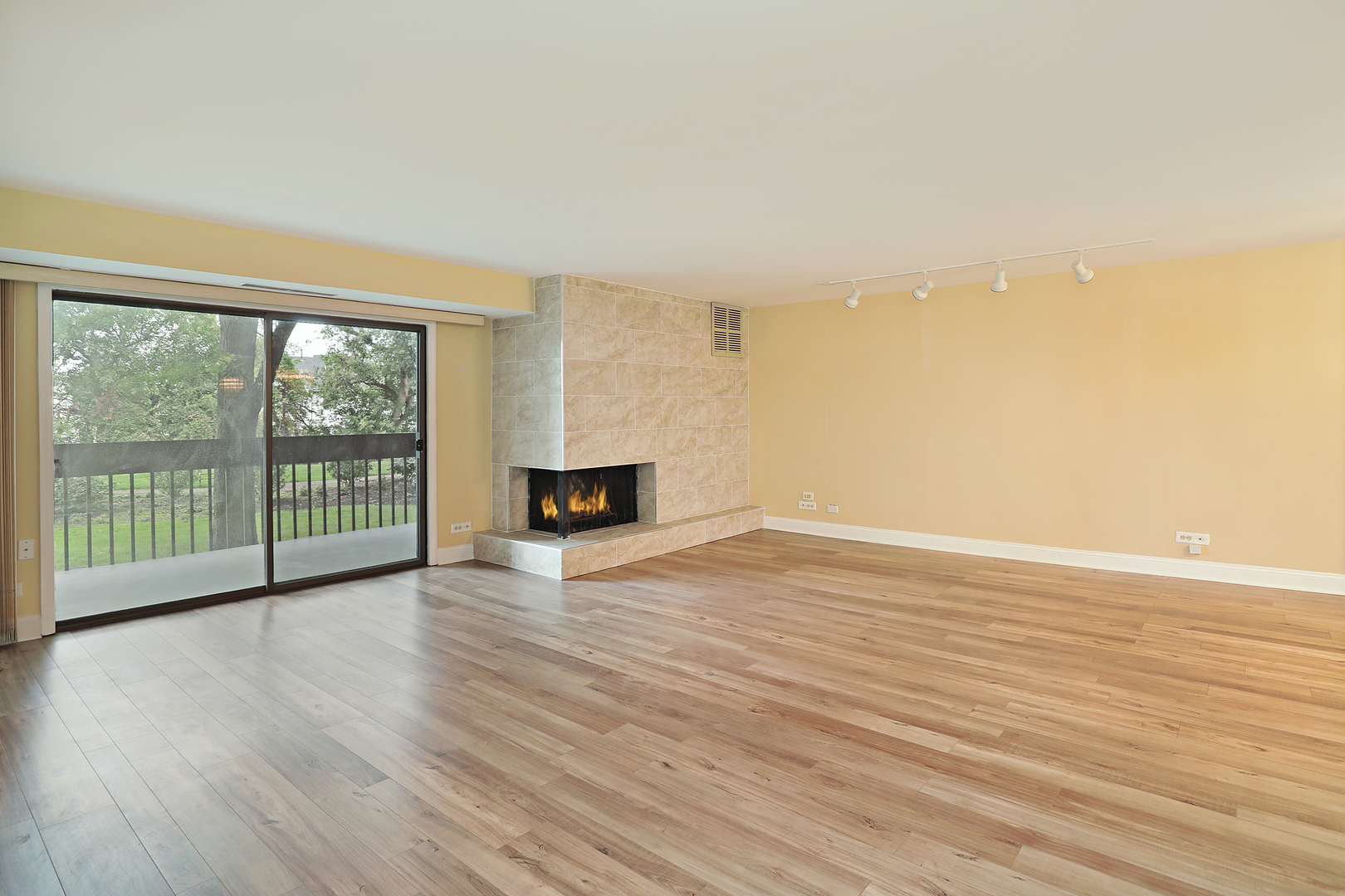 1621 Mission Hills Road, Unit 104 Northbrook, IL 60062 - Photo 21 of 29 a view of empty room with wooden floor and fireplace