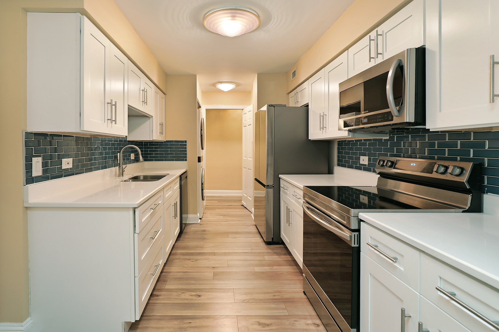 1621 Mission Hills Road, Unit 104 Northbrook, IL 60062 - Photo 25 of 29 a kitchen with stainless steel appliances a stove microwave and sink