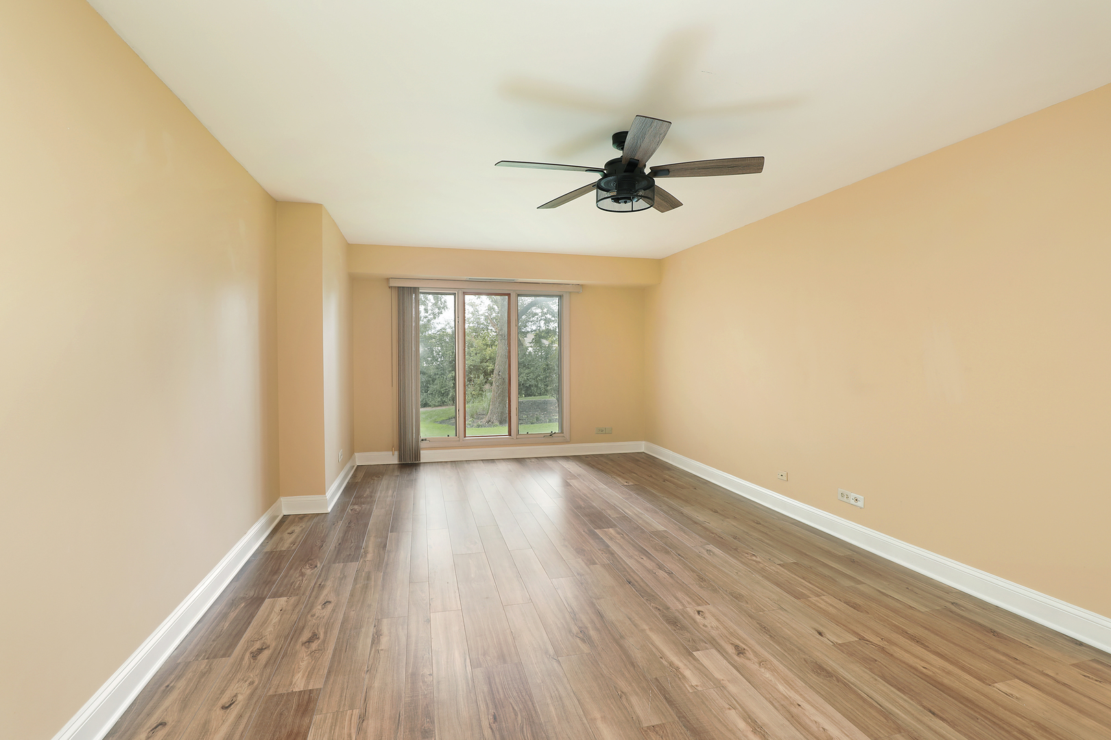 1621 Mission Hills Road, Unit 104 Northbrook, IL 60062 - Photo 26 of 29 an empty room with wooden floor fan and windows