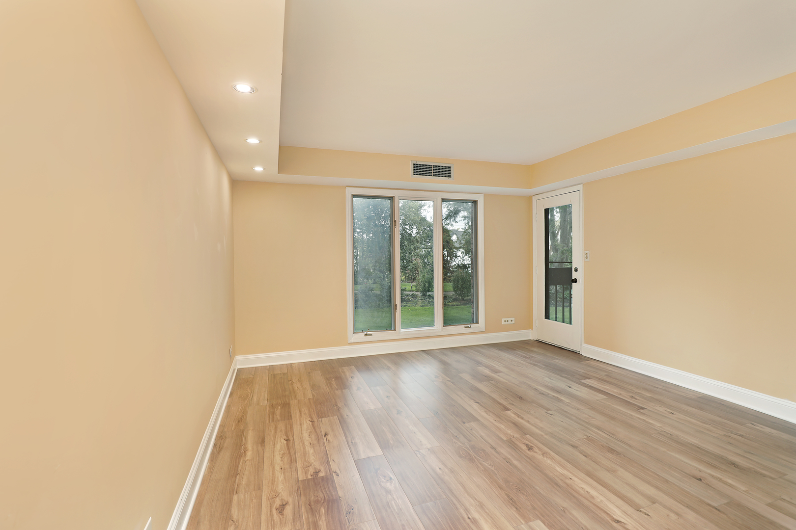 1621 Mission Hills Road, Unit 104 Northbrook, IL 60062 - Photo 28 of 29 wooden floor in an empty room with a window