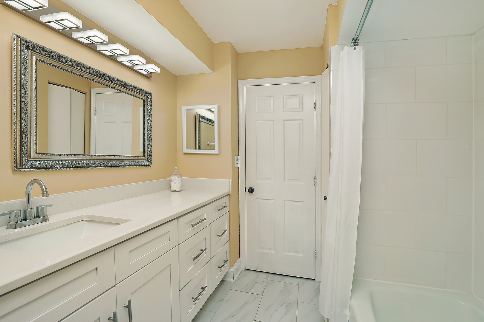 1621 Mission Hills Road, Unit 104 Northbrook, IL 60062 - Photo 29 of 29 a bathroom with a sink a mirror and a shower