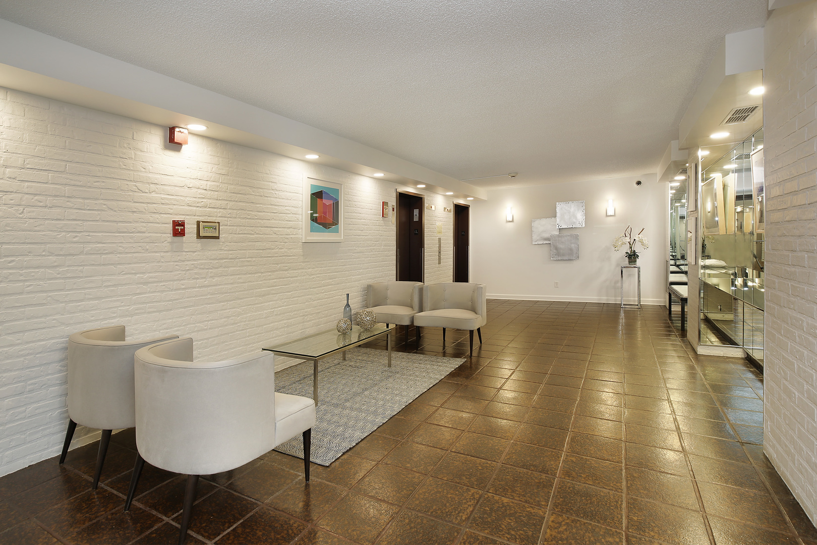 1621 Mission Hills Road, Unit 104 Northbrook, IL 60062 - Photo 4 of 29 a lobby with furniture and a large mirror