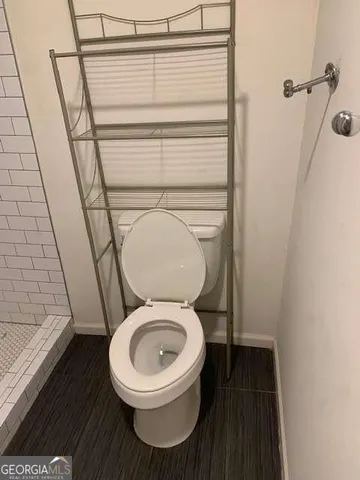a bathroom with a toilet and a shower