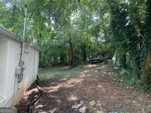 a view of a backyard with large trees