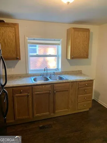a kitchen with granite countertop cabinets sink and window