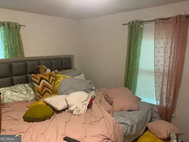 a bedroom with a bed and a window