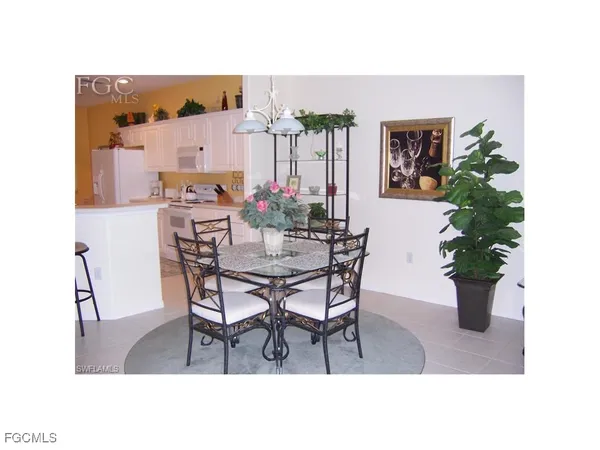 a dining room with furniture and a potted plant