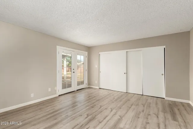 a bathroom with a granite countertop sink a toilet and a mirror