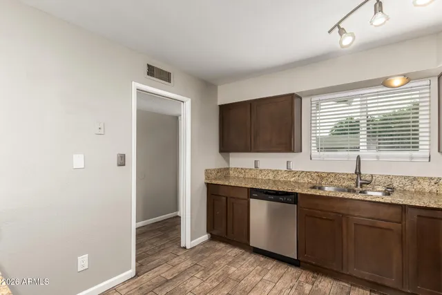 a view of an empty room and wooden floor