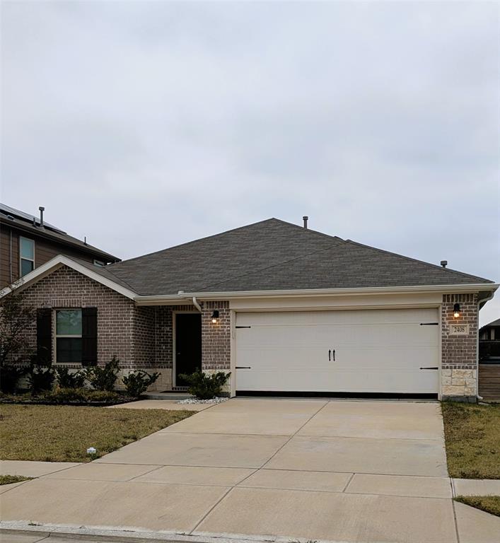 Ranch-style home featuring brick siding, a shingled roof, driveway, an attached garage, and a front lawn