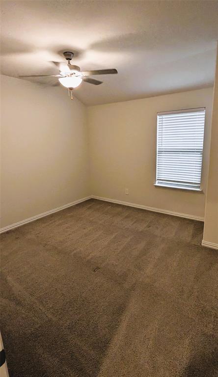 2408 Wildhaven Road Crandall, TX 75114 - Photo 12 of 39 Unfurnished room featuring dark carpet and a ceiling fan