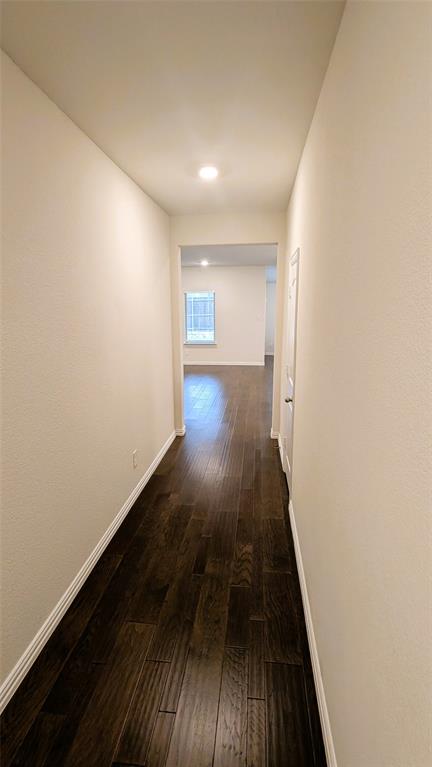 2408 Wildhaven Road Crandall, TX 75114 - Photo 13 of 39 Hallway featuring baseboards and dark wood-style floors
