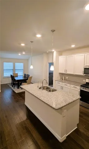 a kitchen with kitchen island a sink stainless steel appliances and cabinets