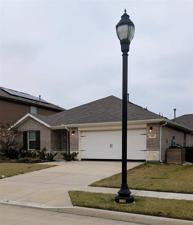 2408 Wildhaven Road Crandall, TX 75114 - Photo 2 of 39 View of front of house featuring brick siding, an attached garage, concrete driveway, a front yard, and roof with shingles
