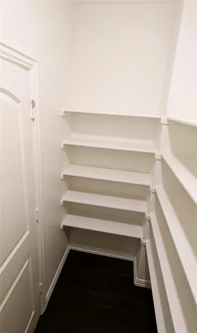 a view of a refrigerator in kitchen and empty room