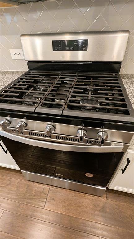 2408 Wildhaven Road Crandall, TX 75114 - Photo 23 of 39 Kitchen view of gas range, decorative backsplash, and light wood-style floors