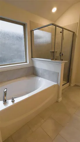 a spacious bathroom with a tub and shower