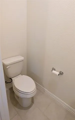 a white toilet sitting next to a shower