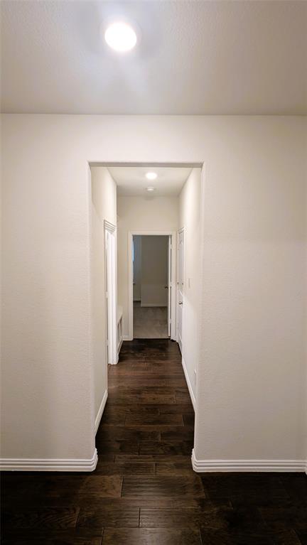 2408 Wildhaven Road Crandall, TX 75114 - Photo 9 of 39 Hallway featuring baseboards and dark wood-type flooring