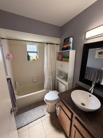 a bathroom with a toilet a sink and a mirror