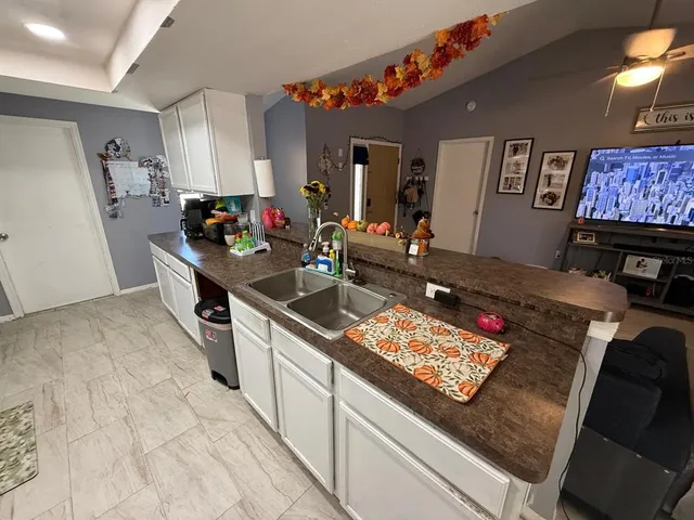 a kitchen that has a sink and a stove in it