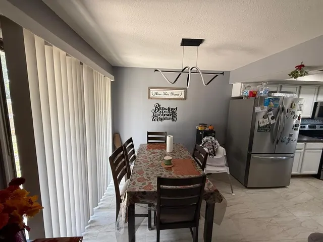 a view of a dining room with furniture window and carpet