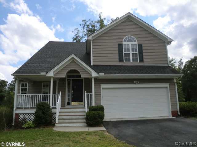 9237 Scotts Bluff Lane Chesterfield, VA 23832 - Photo 1 of 10 a front view of a house with a yard and garage