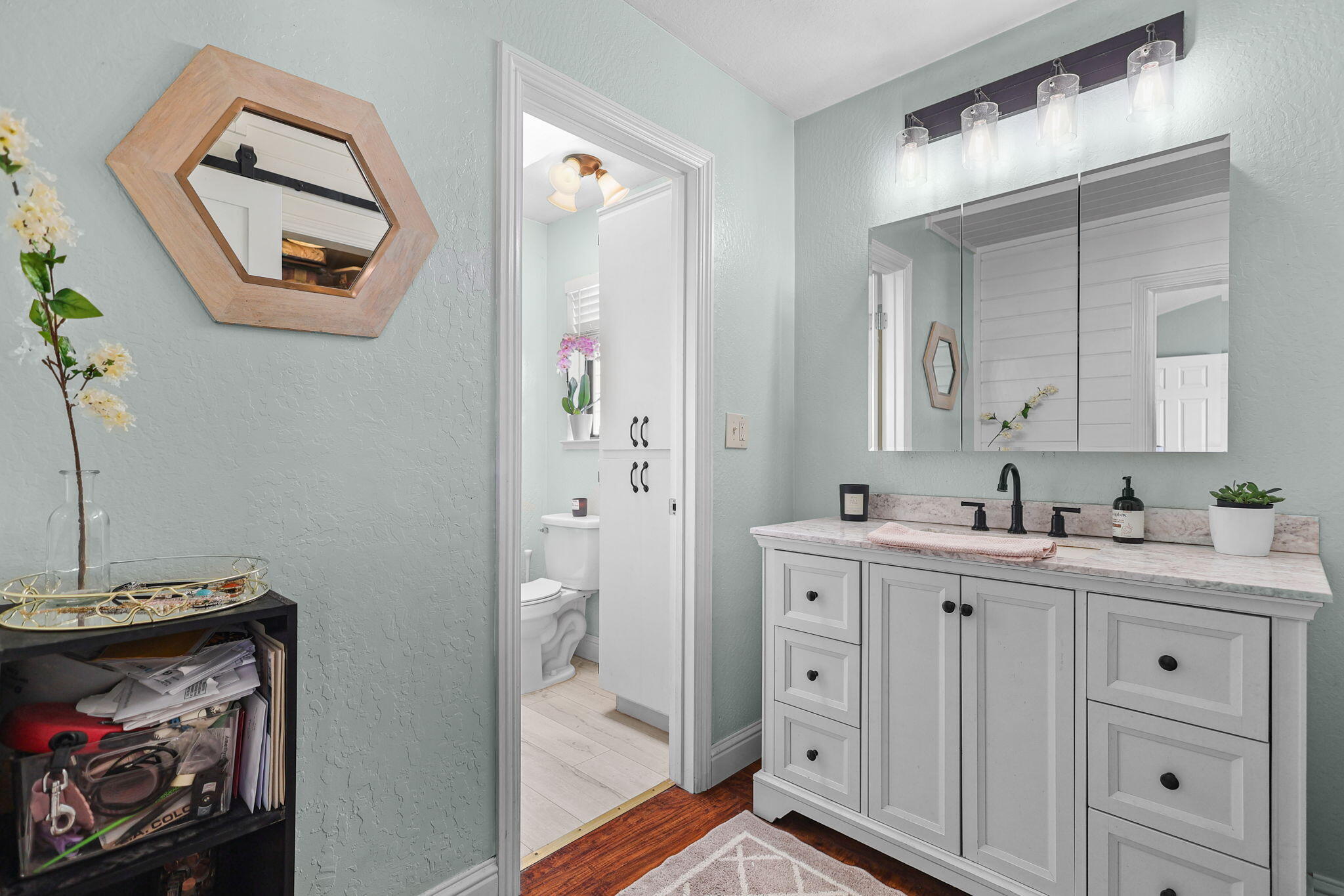 29453 Round Mountain Road Bella Vista, CA 96008 - Photo 14 of 31 a spacious bathroom with a double vanity sink and a mirror