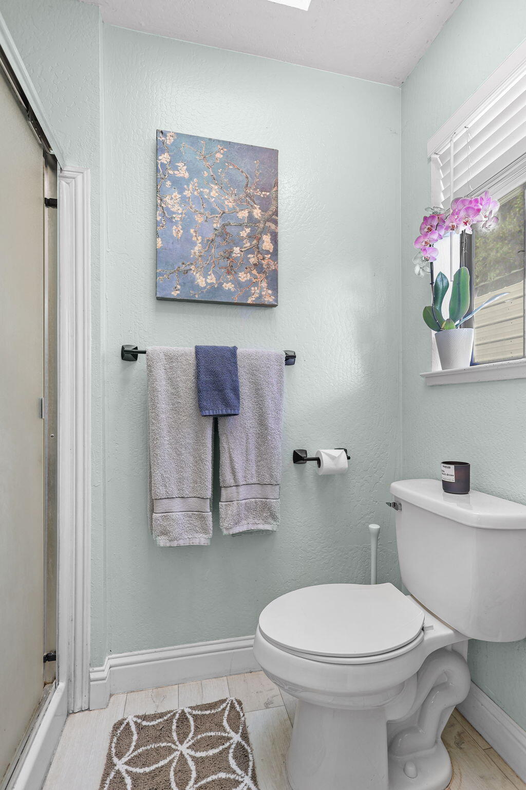 29453 Round Mountain Road Bella Vista, CA 96008 - Photo 16 of 31 a white toilet sitting next to a bathroom sink