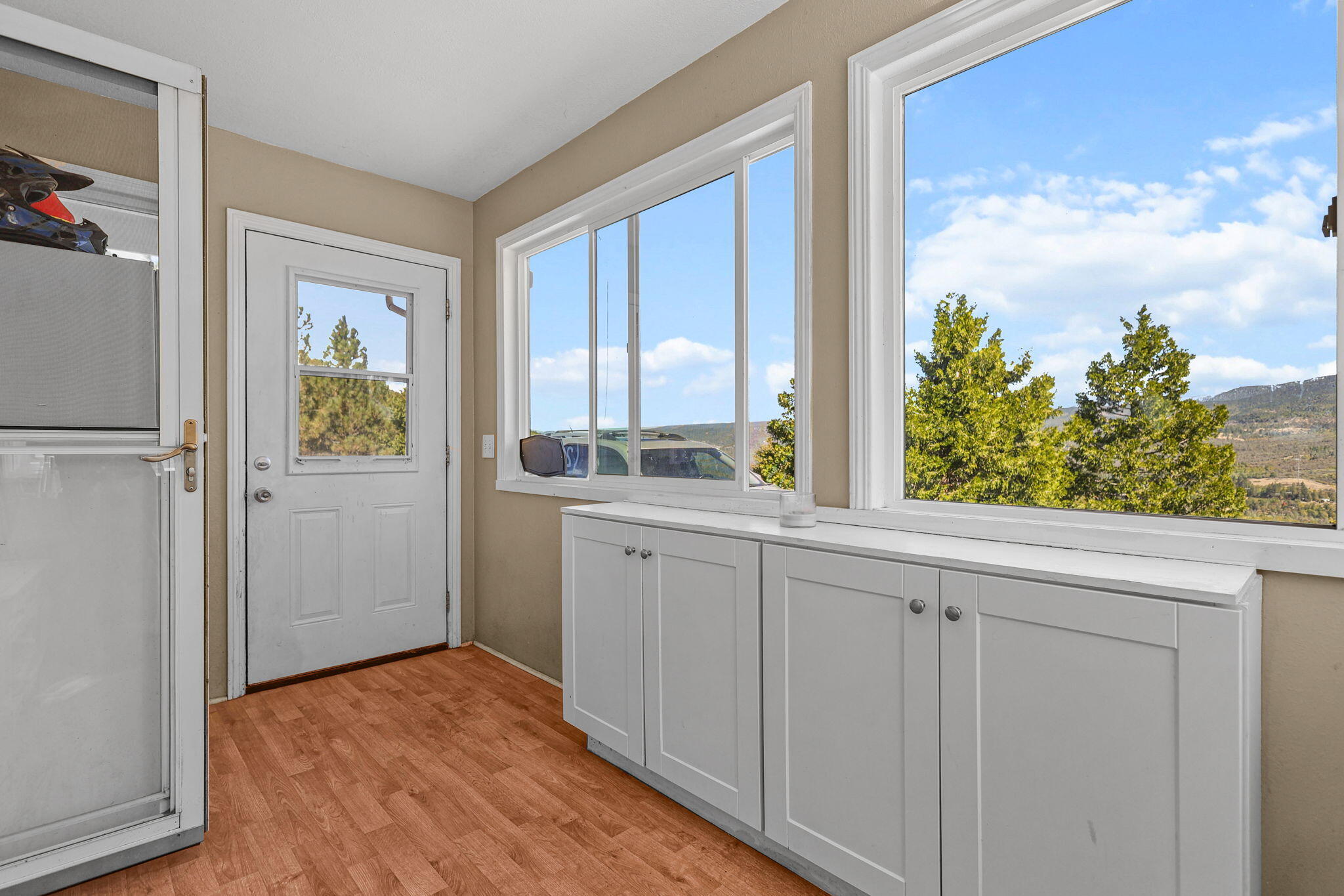 29453 Round Mountain Road Bella Vista, CA 96008 - Photo 21 of 31 a view of a utility room with closet empty shelves and wooden floor