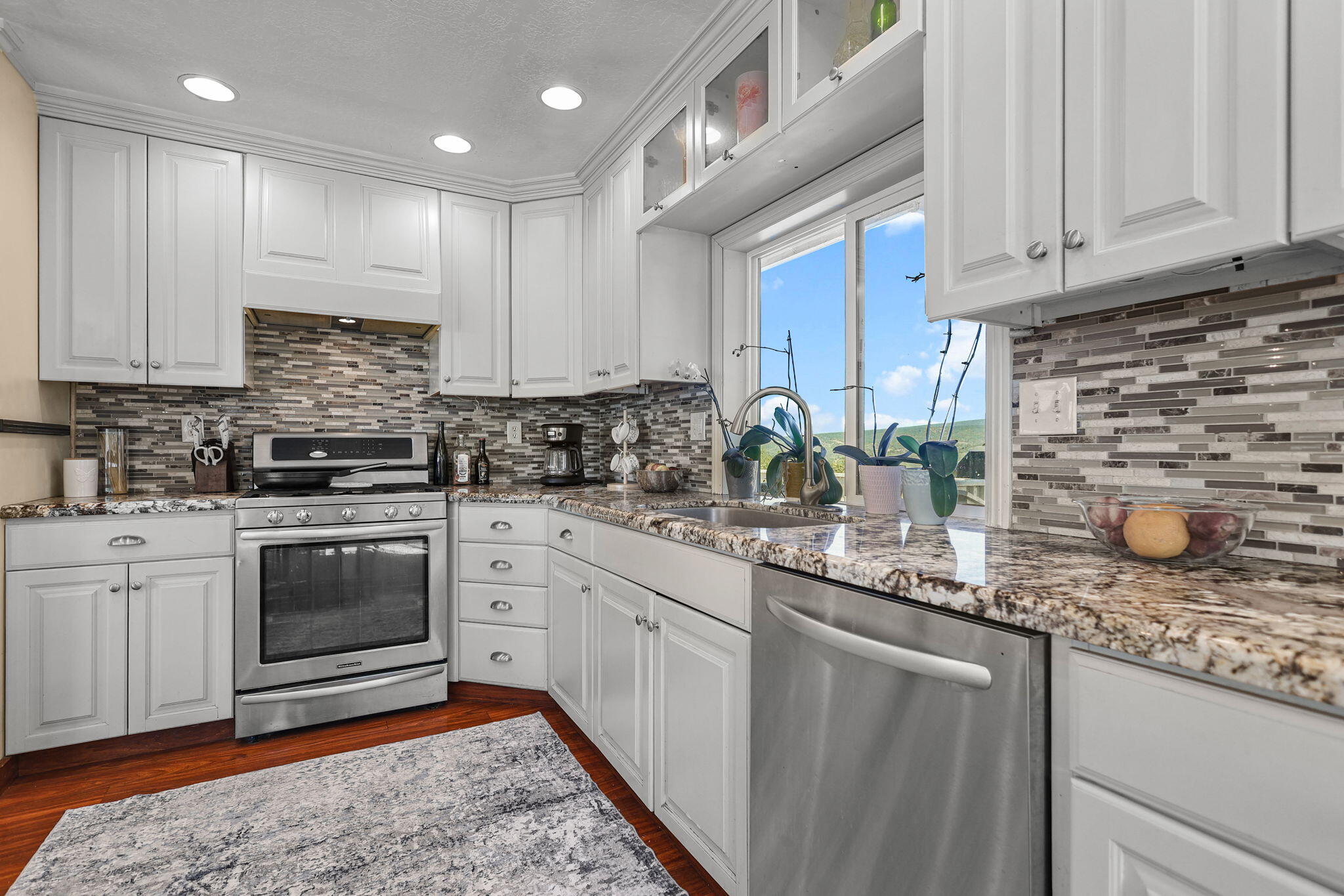 29453 Round Mountain Road Bella Vista, CA 96008 - Photo 6 of 31 a kitchen with stainless steel appliances granite countertop a sink stove and cabinets