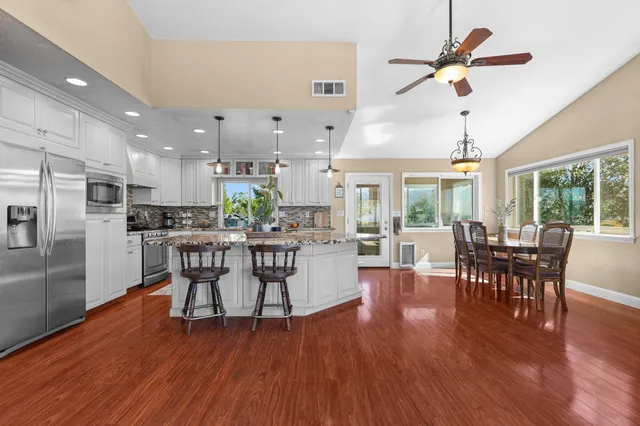 a view of a dining room with furniture window and wooden floor