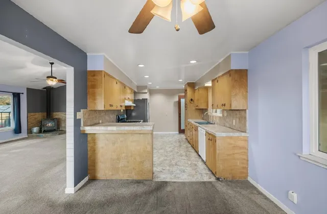 a kitchen with granite countertop a sink and a window